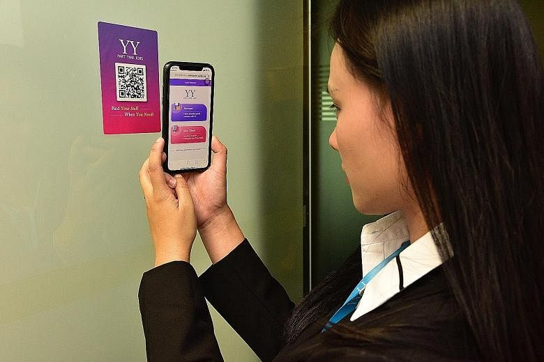 Ms Wendy Wang, IT manager from YY Hong Ye Group, scanning the company's QR code using the updated app in a demonstration yesterday.
