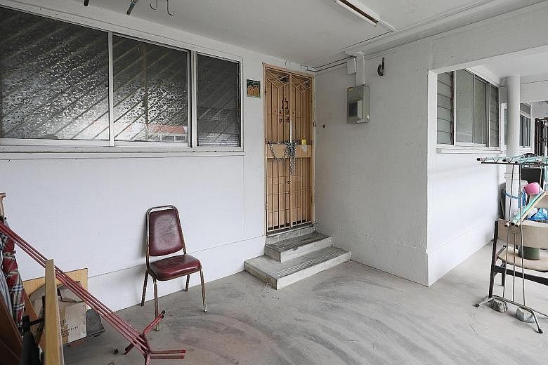 The police found the body of a man's mother in their flat (above) after he was found dead at the foot of their Housing Board block in Little India, where bloodstains (left) can be seen.