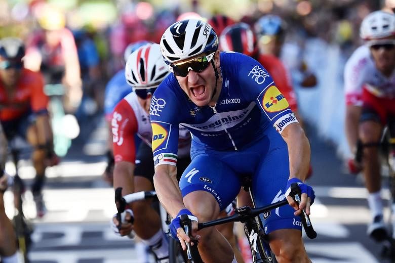 Elia Viviani is in a celebratory mood after winning a bunch sprint to the finish line of the Tour de France's fourth stage from Reims to Nancy.