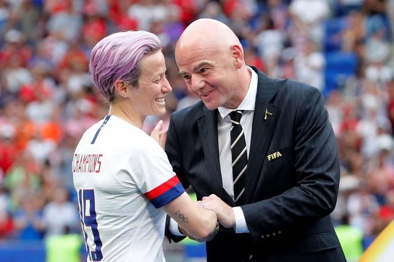 United States forward Megan Rapinoe is congratulated by Fifa president Gianni Infantino before receiving the trophy. She has been outspoken on raising support for the women's game throughout the tournament.