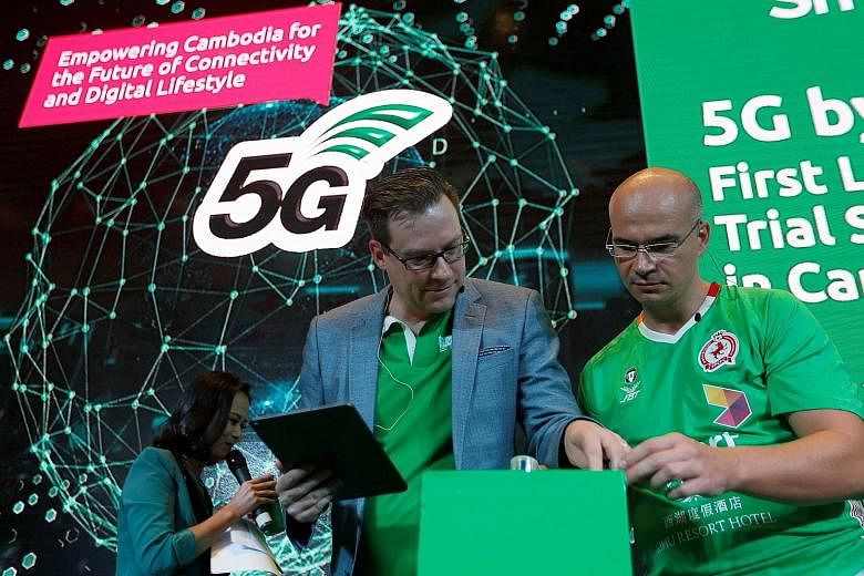 Smart Axiata chief executive Thomas Hundt (centre) at a 5G launch ceremony in Phnom Penh, Cambodia, on Monday. He says Smart Axiata will probably invest hundreds of millions of dollars over the next few years in 5G mobile networks, but it will need t