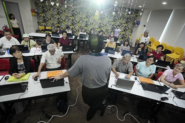 Seniors attending a computer class conducted by a community group. The new Merdeka Generation digital clinics supplement existing educational efforts and are expected to reach about 10,000 seniors over one year.