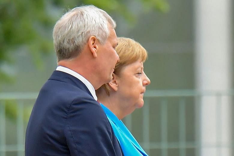 German Chancellor Angela Merkel and Finnish Prime Minister Antti Rinne at the Chancellery yesterday in Berlin, where she was seen shaking.
