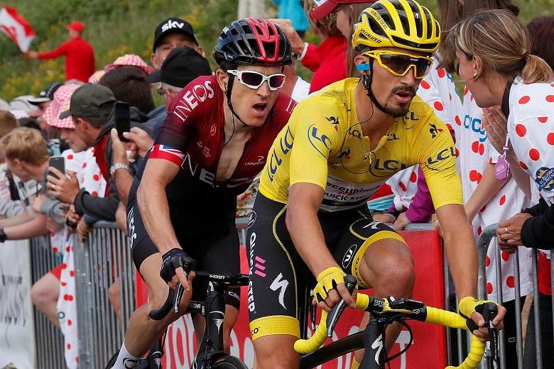 Defending champion Geraint Thomas of Team Ineos and Deceuninck-Quick Step rider Julian Alaphilippe, who would lose the yellow jersey, pushing hard near the end of yesterday's Stage 6 at La Planche des Belles Filles in the Vosges mountains. PHOTO: REU