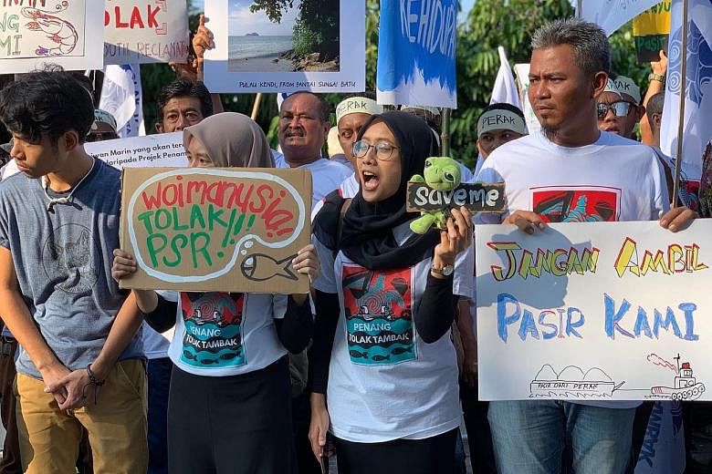 Fishermen from Penang and Perak demonstrating in Kuala Lumpur yesterday against plans for three man-made islands at the border of the two northern states which they say will curtail the livelihoods of about 10,000 people. ST PHOTO: SHANNON TEOH