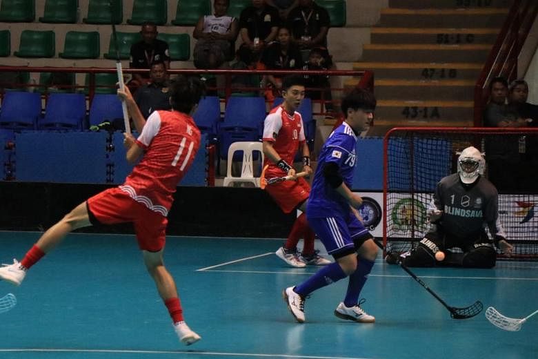 Singapore's Ng Juin Jie (No. 11) taking a shot against South Korea in the semi-finals of the men's Asia Oceania Floorball Confederation Cup in Binan, Philippines yesterday. The Republic won 13-1 to progress to today's final with Thailand, who beat th