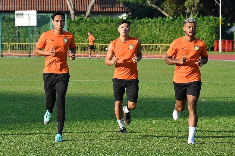 Hougang United players (from far left) Afiq Yunos, Kong Ho-won and Paulin Mbaye training on Thursday ahead of today's match against Albirex at Jurong East.