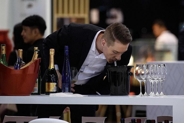 Spitting when tasting wine can bring out "other prevalent aromatic notes" when it mixes with air coming from the nose, says Mr Pierre-Jules Peyrat, a Paris sommelier.