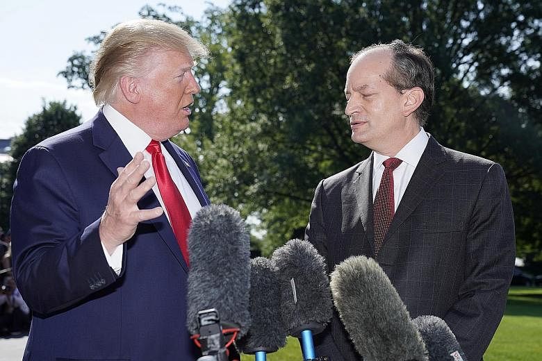US President Donald Trump with Labour Secretary Alex Acosta, who is quitting amid scrutiny of a plea deal he negotiated for Jeffrey Epstein. PHOTO: REUTERS