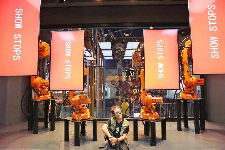 Mr Andy Flessas with his RoboScreens at the Science Centre Singapore. With the help of flexible and fluid robotic arms that can glide, bow and spin, the moving screens put on a show that explains the evolution of engineering. The robot show is part o