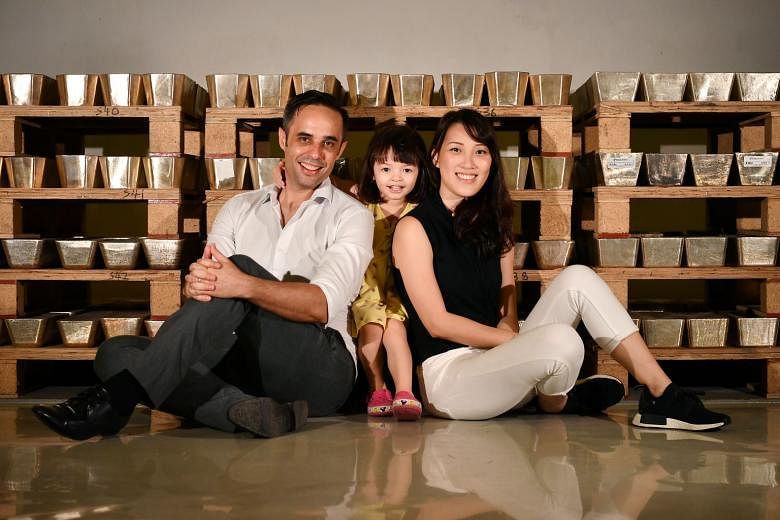 Silver Bullion founder Gregor Gregersen, with his wife Michelle Tay and daughter Daenerys, in front of silver bars at The Safe House, a precious metals vault in Chai Chee. He advocates long-term investing in undervalued assets that have good upside based 