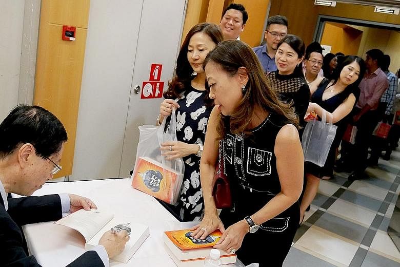 Author Soo Kok Leng autographing copies of his book, Think Wits Win: How To Use Sun Zi's Art Of War For Success, at its launch last Friday.