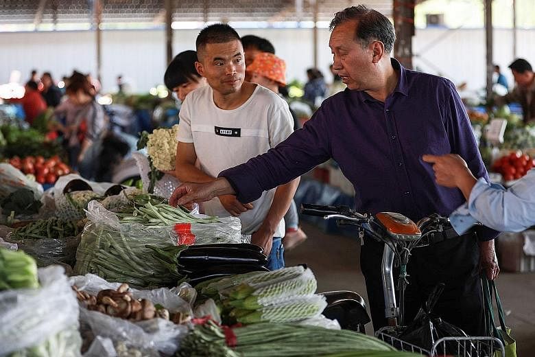 A vegetable stall at a Beijing market. According to a Bloomberg consensus forecast, growth in China is expected to slow slightly to 6.2 per cent year on year from 6.4 per cent in the first quarter. Other key Chinese data, such as June retail sales an