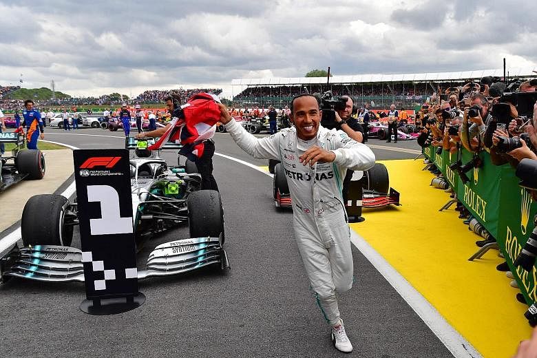 Lewis Hamilton running to celebrate with his team after winning the British Grand Prix at Silverstone yesterday. His Mercedes teammate Valtteri Bottas, who started on pole, looked set for victory until Hamilton pitted under the safety car and gained the a