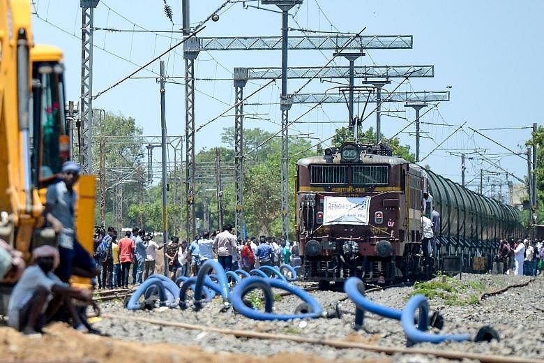 A special train of 50 wagons (above) carrying 2.5 million litres of water at Villivakkam railway station in Chennai last Friday. At left, surgical equipment being washed at a Sudar Hospitals clinic in Chennai, which is among those hard hit by the wat