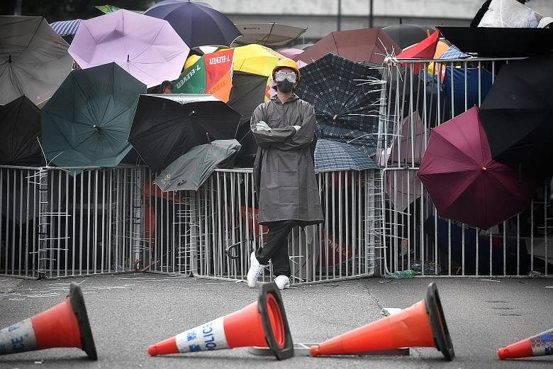 A protester standing defiantly in Hong Kong's Sha Tin district after a rally against a controversial extradition Bill on Sunday. ST PHOTO: CHONG JUN LIANG