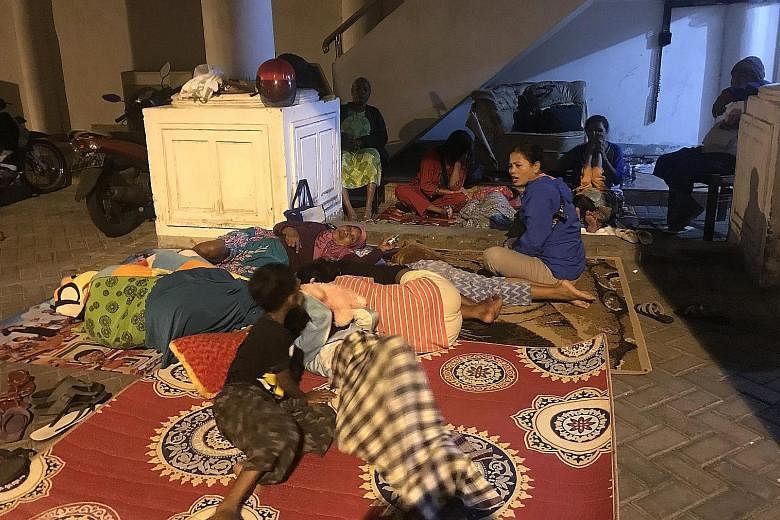 Residents taking refuge at a shelter in Ternate, North Moluccas, on Sunday, following a 7.2-magnitude quake. About 2,000 people have been displaced and at least 58 houses damaged, said a spokesman for Indonesia's National Disaster Mitigation Agency.