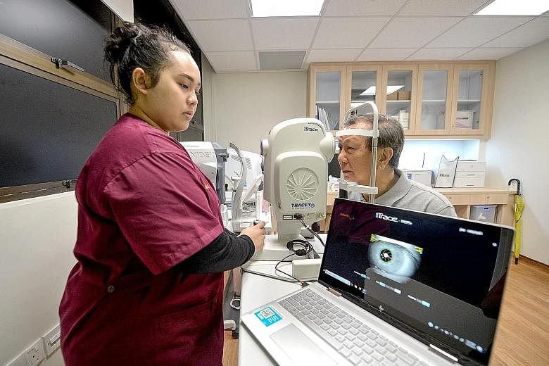 Clockwise from far left: Ophthalmic technician Nur Rasyiqah Jasmi, 25, assessing retiree Geoffrey Foo, 75, with an iTrace machine for the implant of special lenses for cataract patients with high astigmatism at Alexandra Hospital yesterday; Mr Foo at