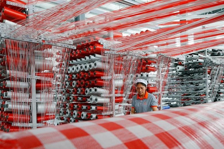 A worker at a plastic packaging factory in China's Jiangsu province. It was not all bad news as China's industrial production last month grew 6.3 per cent year on year. PHOTO: REUTERS