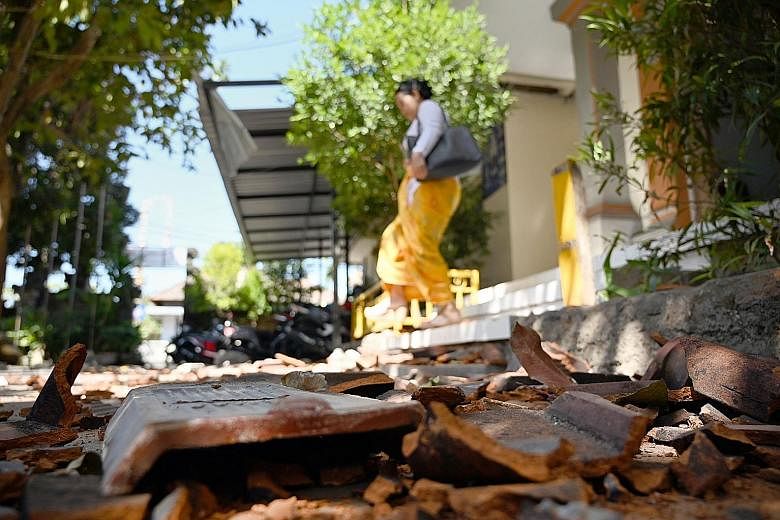 Tiles from the damaged roof of a school littering the ground after an earthquake struck south of Indonesia's resort island of Bali yesterday. There were no reports of casualties and no tsunami warning was issued.