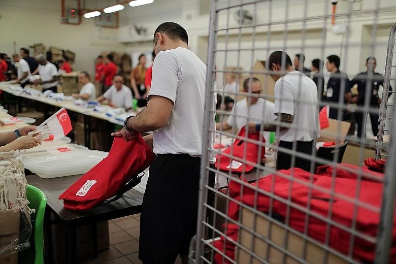 For the past three weeks, 30 Changi Prison inmates have been packing National Day Parade funpacks, as a way to give back to society. They volunteered for the project and are working to pack 50,000 funpacks by the end of this month. It is the first ti