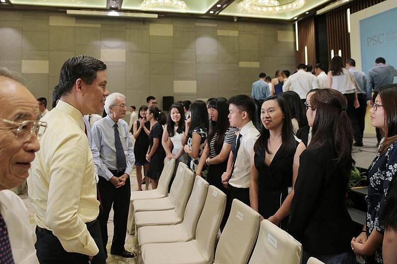 Mr Chan Chun Sing, who is Minister-in-charge of the Public Service, chatting with scholarship recipients at yesterday's Public Service Commission Scholarships Award Ceremony at Parkroyal on Beach Road hotel.