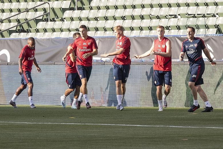 Arsenal players limbering up on Tuesday, ahead of their International Champions Cup match against FC Bayern Munich in California this morning (Singapore time).