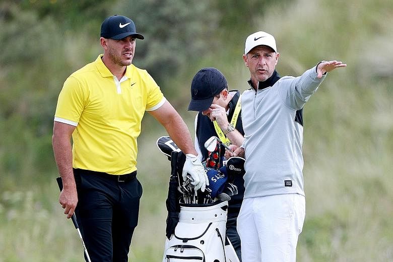 Caddie Ricky Elliott with world No. 1 Brooks Koepka during practice at Royal Portrush Golf Club, Northern Ireland, earlier this week. Elliott, a well-known figure in Portrush, has been working with Koepka for six years now.