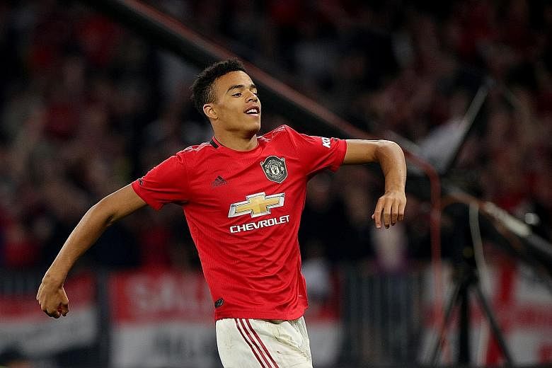 Mason Greenwood celebrating after netting the opener against Leeds. The 17-year-old striker will have a role to play off the bench next term. PHOTO: DPA