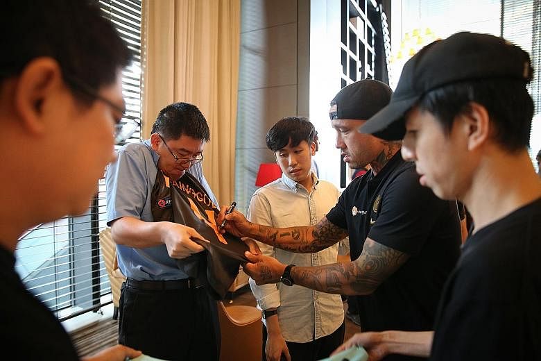 Inter Milan's Radja Nainggolan signing autographs for fans in the hotel lobby, soon after his team arrived and checked into the JW Marriott Hotel Singapore South Beach yesterday.