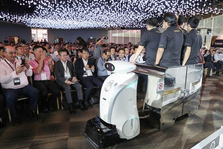LeoPull, a robot that can transport up to 450kg of cleaning equipment, on show at the launch event yesterday. Local firm LionsBot International has developed 13 different robot models that can scrub, mop, vacuum, sweep, shine and even transport clean
