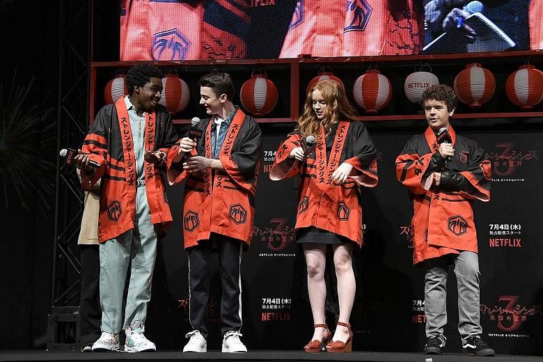 The cast of Netflix original drama Stranger Things - (from far left) Caleb McLaughlin, Noah Schnapp, Sadie Sink and Gaten Matarazzo - in specially made traditional Japanese festival coats at a fan event in Tokyo this month. Looking ahead, Netflix pro