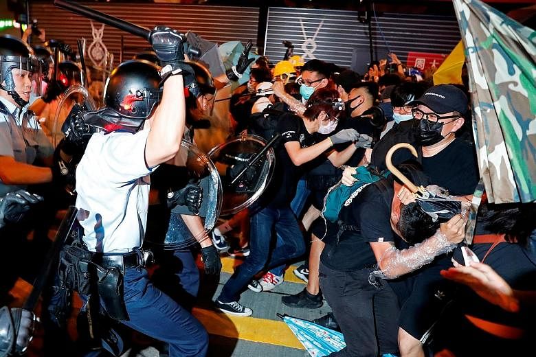 Hong Kong's riot police clashing with protesters after a march this month. A risk mitigation consulting firm says the Hong Kong government's desire to not inflame matters has had the opposite effect - prompting clashes between protesters and police, 