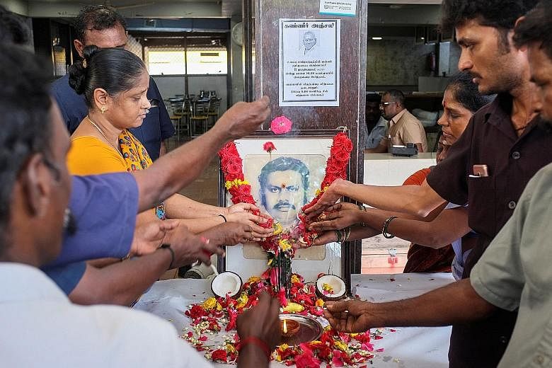 Employees paying tribute to Indian restaurant tycoon P. Rajagopal in Chennai yesterday.