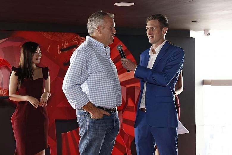 What's New's trainer Cliff Brown is interviewed by Singapore Turf Club broadcaster Luke Marlow at yesterday's Singapore Derby post position draw. The horse has already won the Silver Bowl and Stewards' Cup.