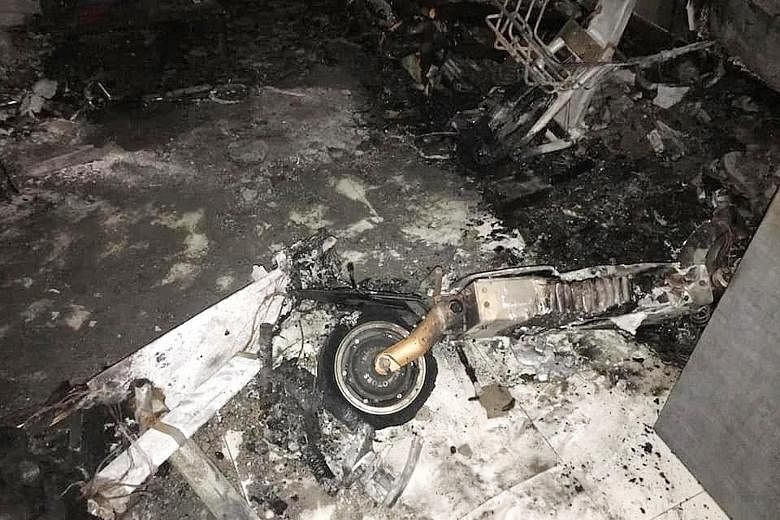 The fire in the living room (left) of a unit on the 26th floor of Block 293D Bukit Batok Street 21 was traced to two e-scooters (above). An unconscious man with burn injuries and a woman who suffered smoke inhalation were taken to hospital.