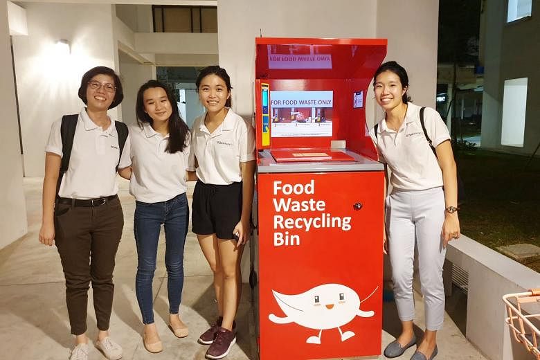 Ms Pek Hai Lin (far right) with staff from Zero Waste SG during an outreach effort earlier this year as part of a food-waste recycling pilot at Tampines Greenlace estate. She received the EcoFriend Award yesterday from Minister for the Environment an
