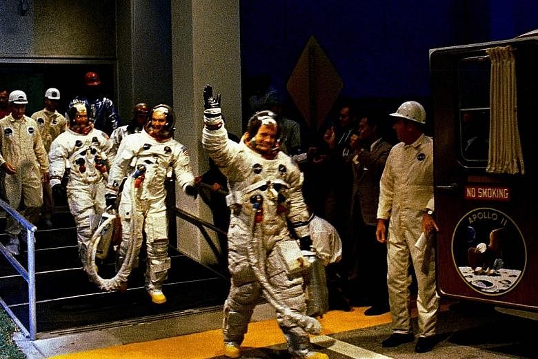 The crew leaving the manned spacecraft operations building during the pre-launch countdown.
