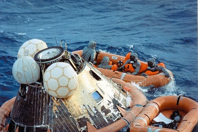 The astronauts waiting to be picked up during recovery operations in the Pacific Ocean on July 24, 1969.