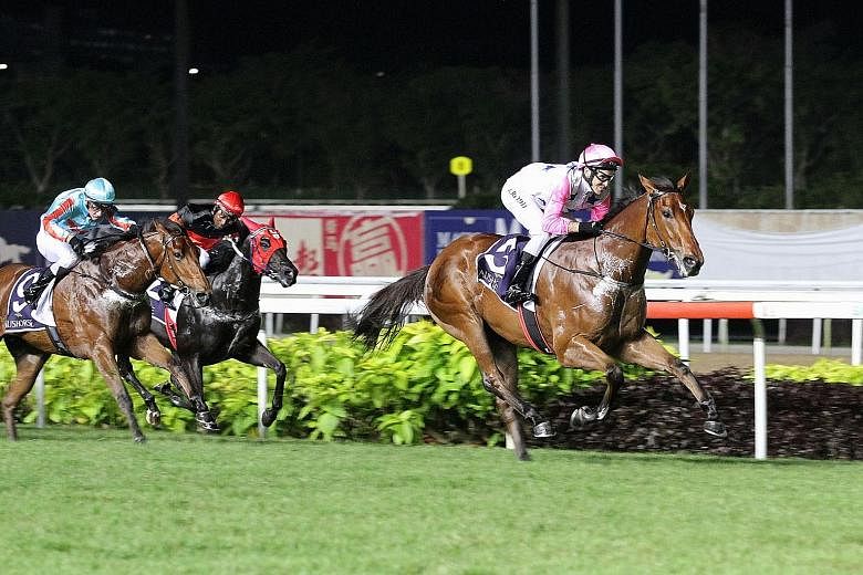 Debut winner Inferno (left) powering home to take the $250,000 Group 2 Aushorse Golden Horseshoe over 1,200m in Race 5 at Kranji last night. It was jockey Michael Rodd's fourth winner of the night.