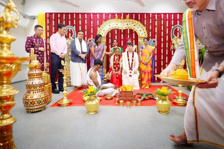 Mock Indian (above), Malay and Chinese wedding ceremonies being performed by the staff and students of Chua Chu Kang Secondary School in celebration of Singapore's diversity, with Minister for Education Ong Ye Kung (above, left) looking on. 