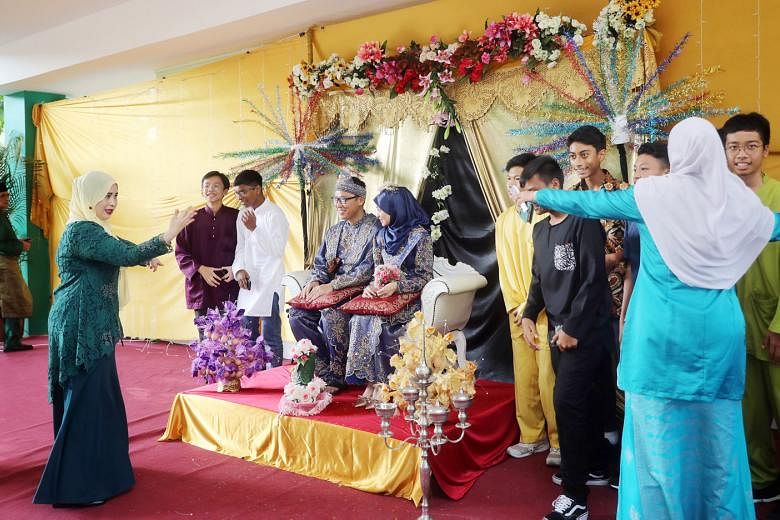 Mock Indian, Malay (above) and Chinese wedding ceremonies being performed by the staff and students of Chua Chu Kang Secondary School in celebration of Singapore's diversity, with Minister for Education Ong Ye Kung looking on. 