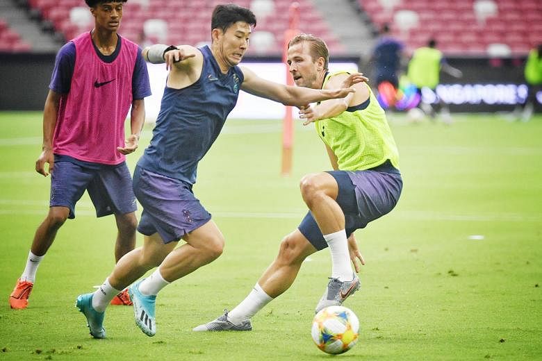 Tottenham captain Harry Kane challenging fellow forward Son Heung-min for the ball during their training session at the National Stadium yesterday. ST PHOTO: CHONG JUN LIANG