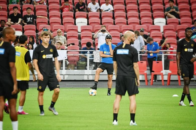 Above: Coach Antonio Conte (in cap) has confirmed that Inter Milan have their eye on Manchester United striker Romelu Lukaku (left), who arrived in Singapore on Thursday night. Inter Milan players including (from far left) Andrea Ranocchia, Facundo C