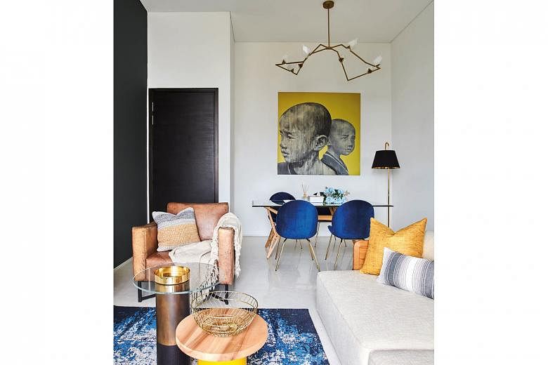 Shades of blue, yellow and brass in the palette give the apartment a lively vibe.