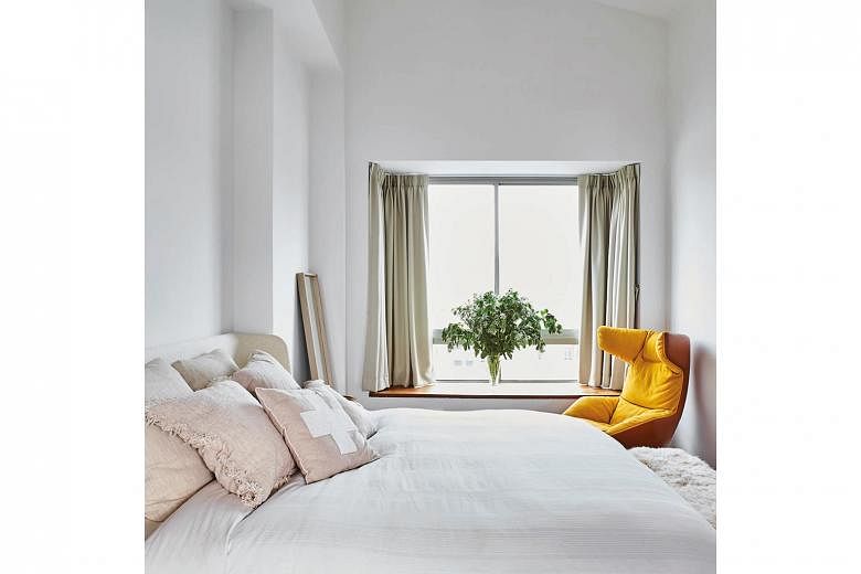 The mainly white bedroom gets a spot of colour from the Take A Line For A Walk chair by Moroso.