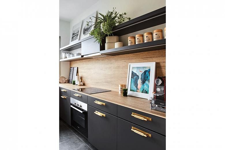 A wood-like countertop adds contrast to the mostly black kitchen.