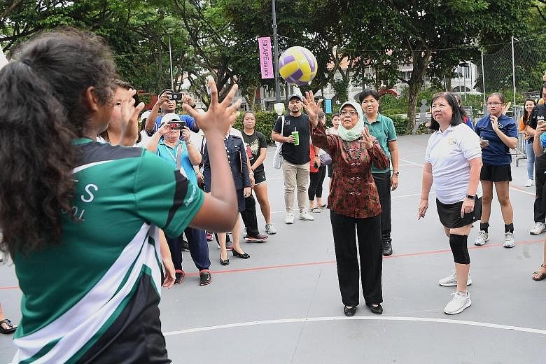 President Halimah Yacob taking part in a netball game at an event in support of the President's Challenge Volunteer Drive 2019 at *Scape yesterday. The President's Challenge has rallied over 6,000 volunteers since the start of the year, more than 80 