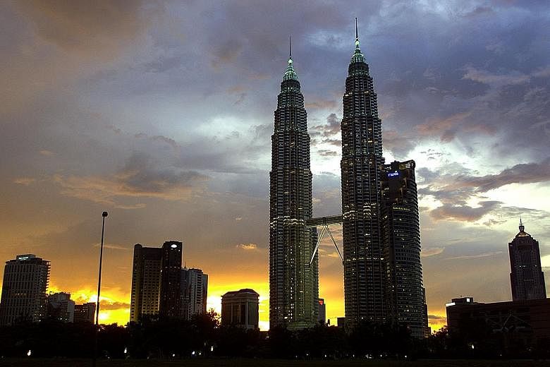 Mr Cesar Pelli's many celebrated works include the Petronas Towers (top) in Kuala Lumpur. His firm was also responsible for the architectural design concept of Ocean Financial Centre (left) in Singapore. PHOTOS: AGENCE FRANCE-PRESSE, ST FILE