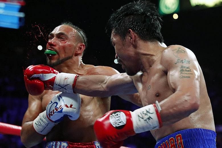Manny Pacquiao landing a punch that leaves Keith Thurman bloodied in their WBA welterweight title fight at the MGM Grand Garden Arena in Las Vegas, Nevada, on Saturday night. Pacquiao won by a split decision.